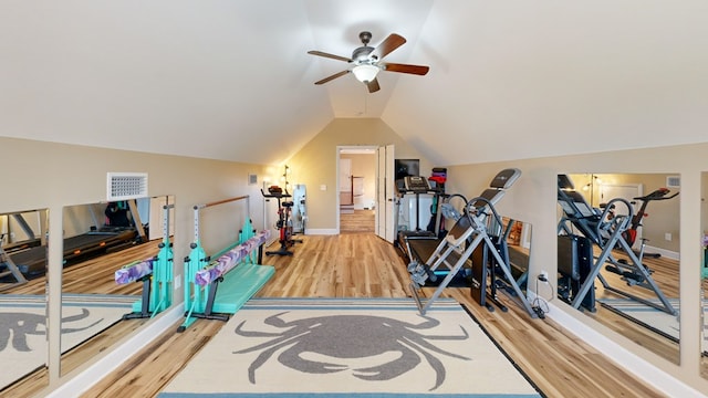 exercise room featuring wood-type flooring, vaulted ceiling, and ceiling fan