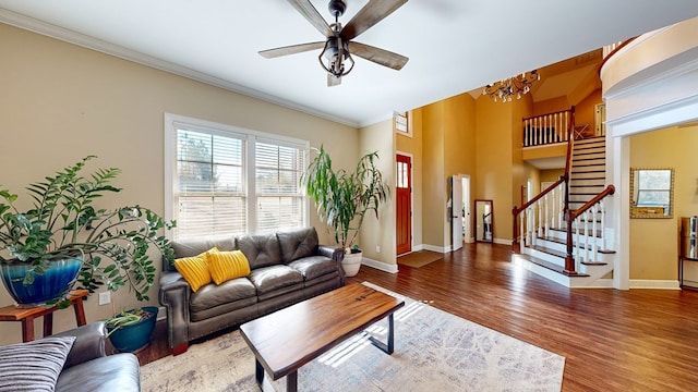 living room with crown molding, ceiling fan, and wood-type flooring