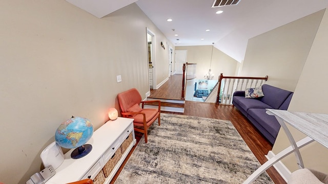 living area with vaulted ceiling and dark wood-type flooring