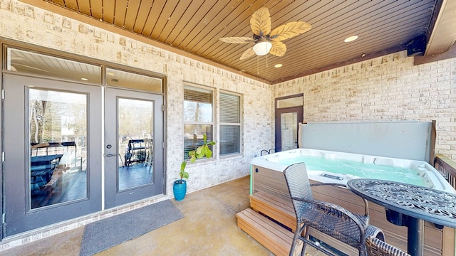 view of patio / terrace featuring french doors, ceiling fan, and a hot tub