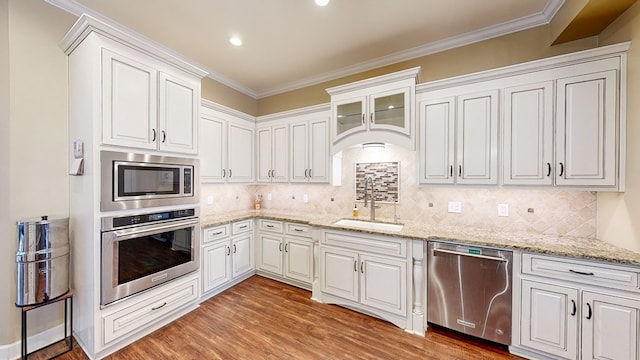 kitchen with white cabinetry, sink, light wood-type flooring, and appliances with stainless steel finishes