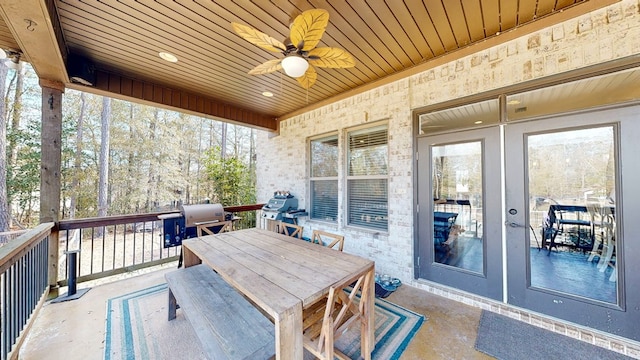 sunroom with wood ceiling and ceiling fan