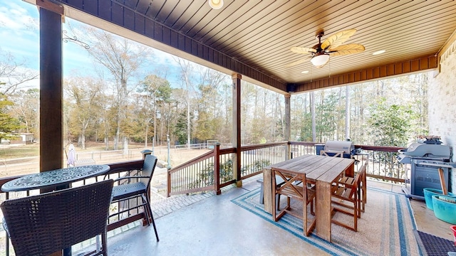 sunroom / solarium with ceiling fan and wooden ceiling