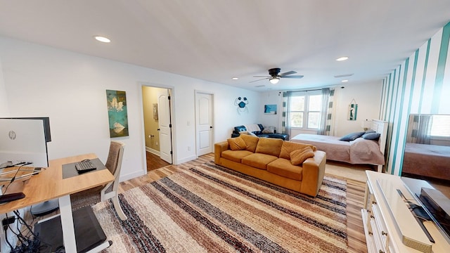 bedroom with ceiling fan and light hardwood / wood-style floors