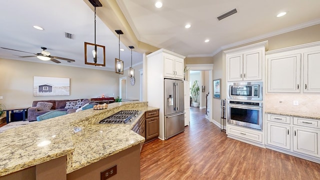 kitchen featuring stainless steel appliances, crown molding, white cabinets, and dark hardwood / wood-style flooring