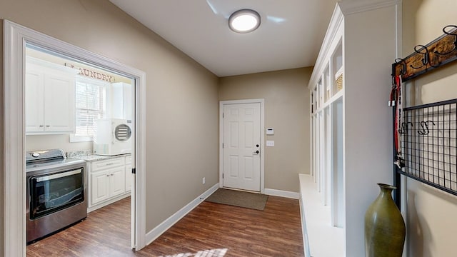 interior space with dark hardwood / wood-style floors and washer / clothes dryer