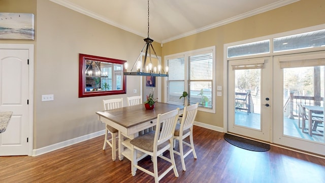 dining room with ornamental molding, dark hardwood / wood-style floors, and french doors