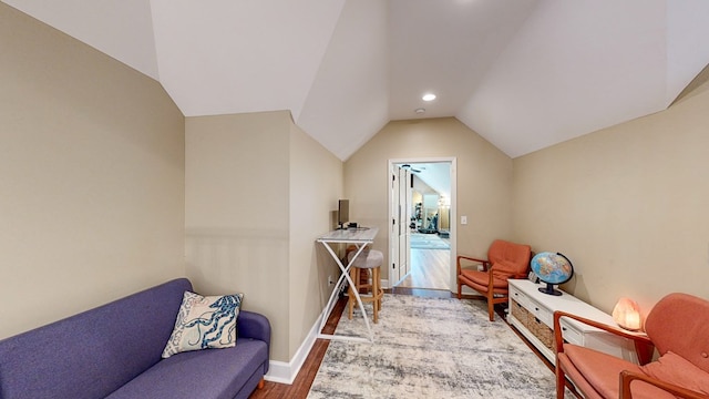 sitting room featuring vaulted ceiling and hardwood / wood-style floors