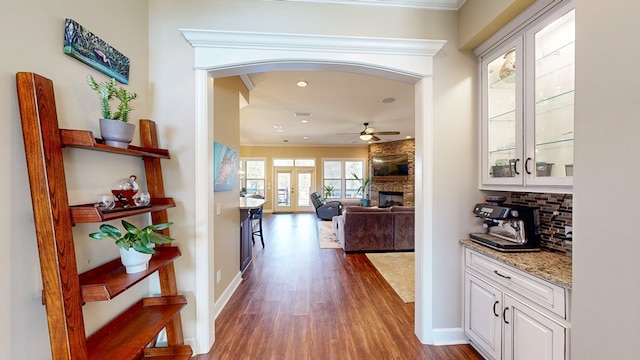 corridor with dark wood-type flooring and french doors