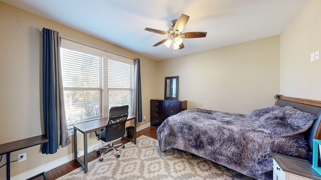 bedroom with ceiling fan and light wood-type flooring