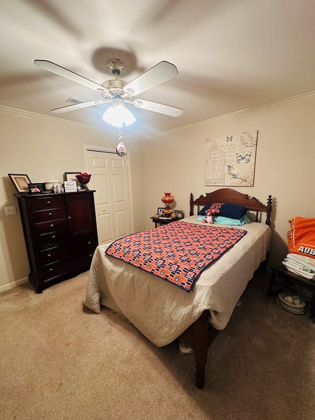 bedroom with a closet, light colored carpet, ornamental molding, and a ceiling fan