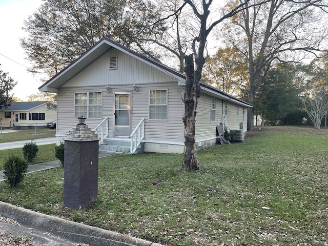 bungalow-style house with central AC and a front lawn