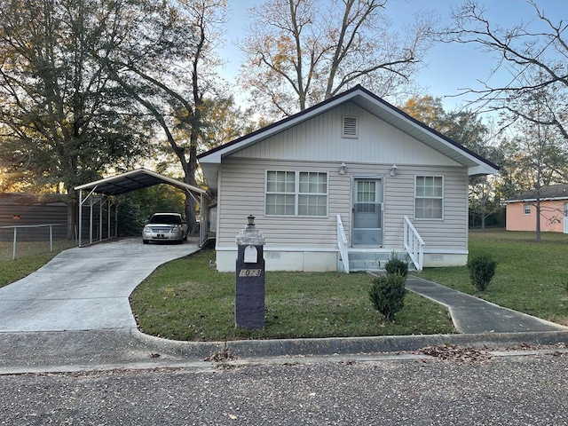 bungalow-style house featuring a carport and a front lawn