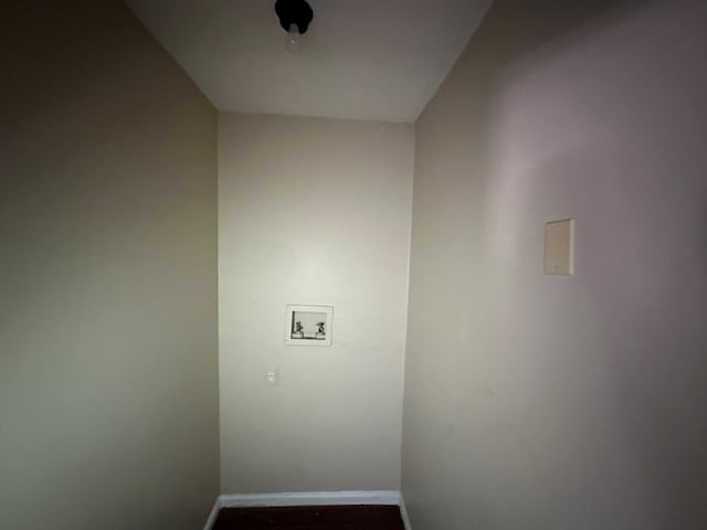 washroom featuring dark wood-style floors, baseboards, hookup for a washing machine, and laundry area