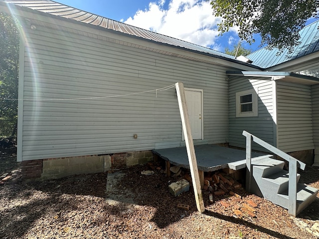 view of property exterior featuring metal roof