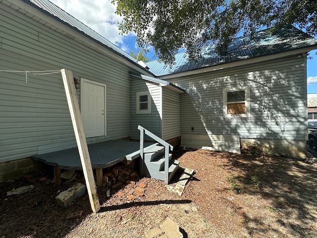 view of side of home featuring metal roof