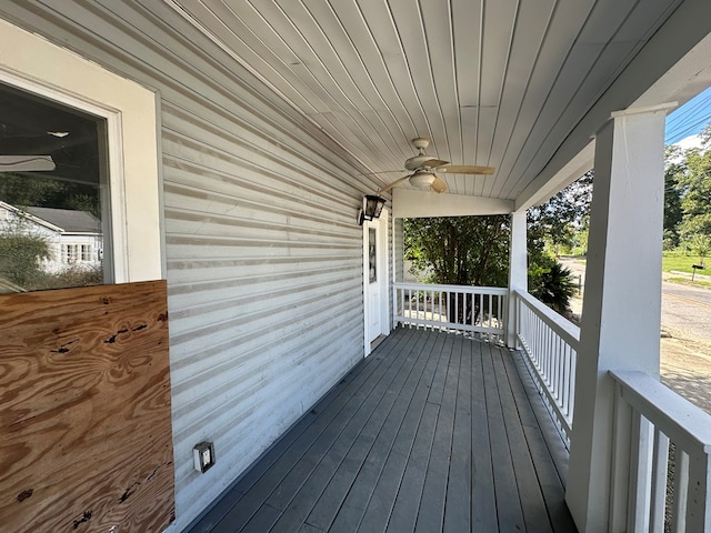 wooden deck featuring a porch and ceiling fan