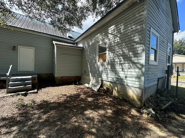 view of property exterior featuring metal roof