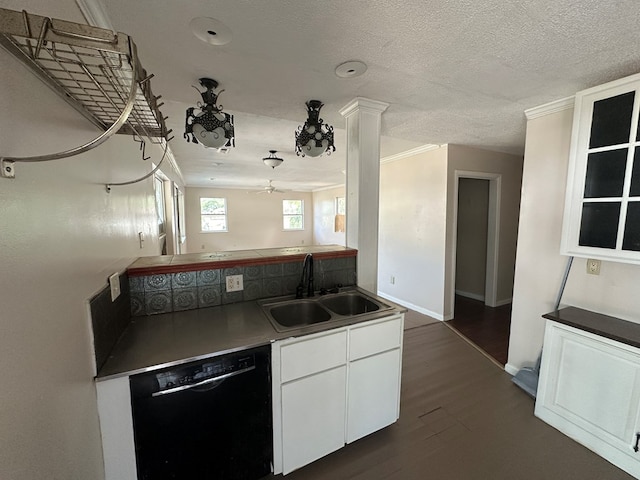 kitchen with dark wood finished floors, a sink, black dishwasher, a textured ceiling, and white cabinetry