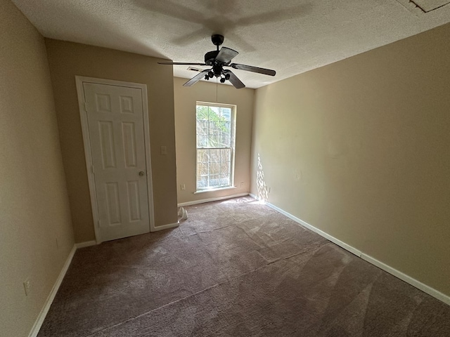 carpeted empty room featuring a textured ceiling, baseboards, and ceiling fan