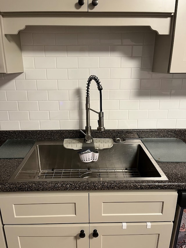 16 Holman St, Daleville, AL 36322 - kitchen view of tasteful backsplash, white cabinetry, and dark stone countertops