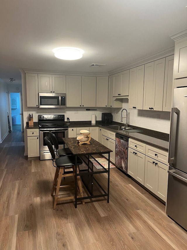 16 Holman St, Daleville, AL 36322 - kitchen featuring stainless steel appliances, dark wood finished floors, decorative backsplash, and dark countertops