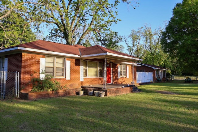 407 S Washington St, Columbia, AL 36319 - view of front facade featuring fence, a front lawn, and brick siding