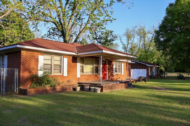 407 S Washington St, Columbia, AL 36319 - view of front of house featuring fence, a front lawn, and brick siding