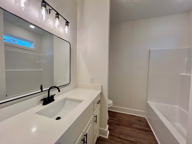 bathroom with vanity, toilet, and hardwood / wood-style floors