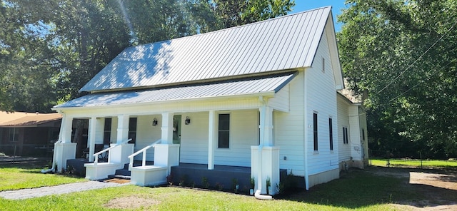207 W Pullum St, Samson, AL 36477 - view of front of property featuring a porch, a front lawn, and a metal roof