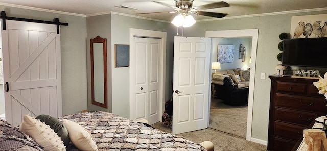 207 W Pullum St, Samson, AL 36477 - bedroom featuring light colored carpet, a barn door, a closet, ornamental molding, and a ceiling fan