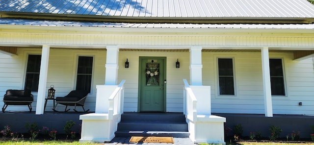 207 W Pullum St, Samson, AL 36477 - doorway to property featuring a porch and a metal roof