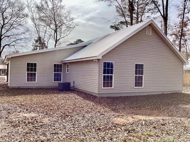 back of house featuring cooling unit