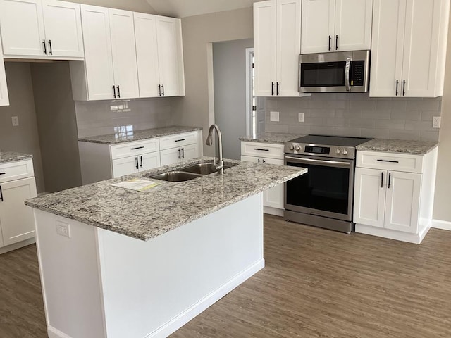 kitchen featuring an island with sink, appliances with stainless steel finishes, and white cabinets