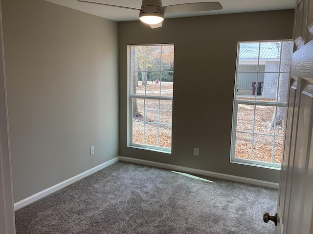 carpeted spare room with ceiling fan