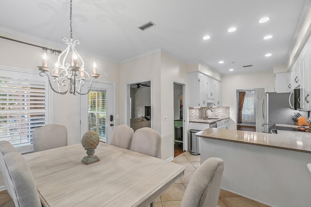108 Mulberry Ct, Dothan, AL 36303 - dining room with a chandelier, light tile patterned floors, ornamental molding, and recessed lighting