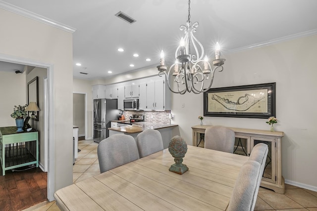 108 Mulberry Ct, Dothan, AL 36303 - dining space with a chandelier, crown molding, light tile patterned floors, and recessed lighting