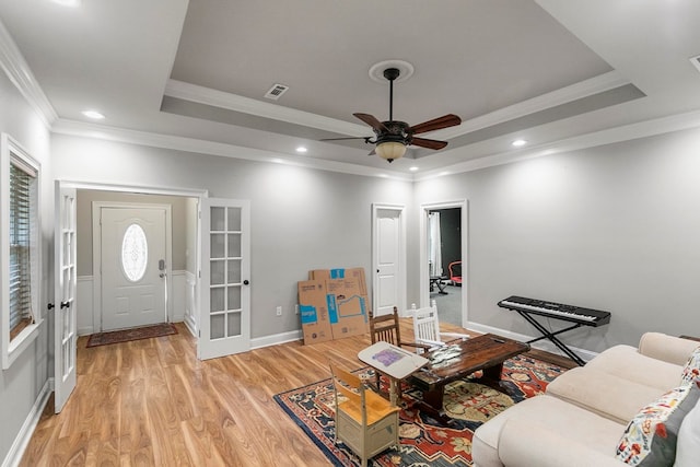 108 Mulberry Ct, Dothan, AL 36303 - living area with a tray ceiling, light wood finished floors, crown molding, ceiling fan, and french doors