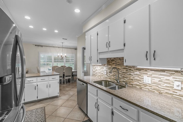 108 Mulberry Ct, Dothan, AL 36303 - kitchen with appliances with stainless steel finishes, decorative backsplash, white cabinets, light tile patterned flooring, and recessed lighting