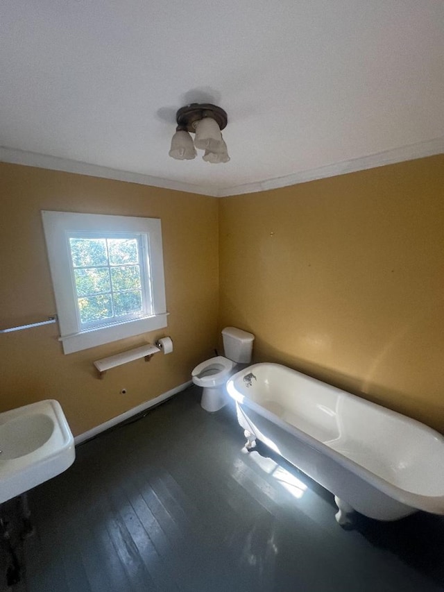 bathroom featuring a bathing tub, sink, crown molding, toilet, and wood-type flooring