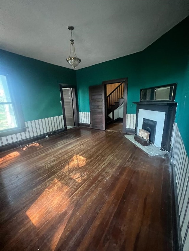 unfurnished living room with dark wood-type flooring