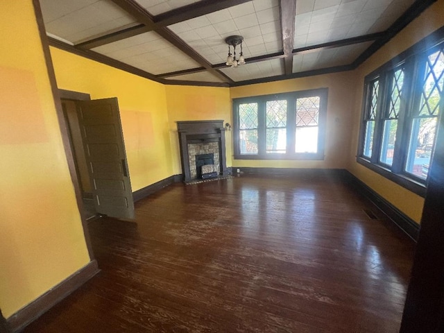 unfurnished living room with a fireplace, beam ceiling, and dark hardwood / wood-style floors