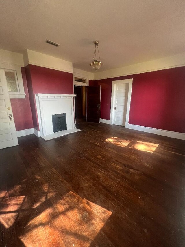 unfurnished living room with dark hardwood / wood-style floors