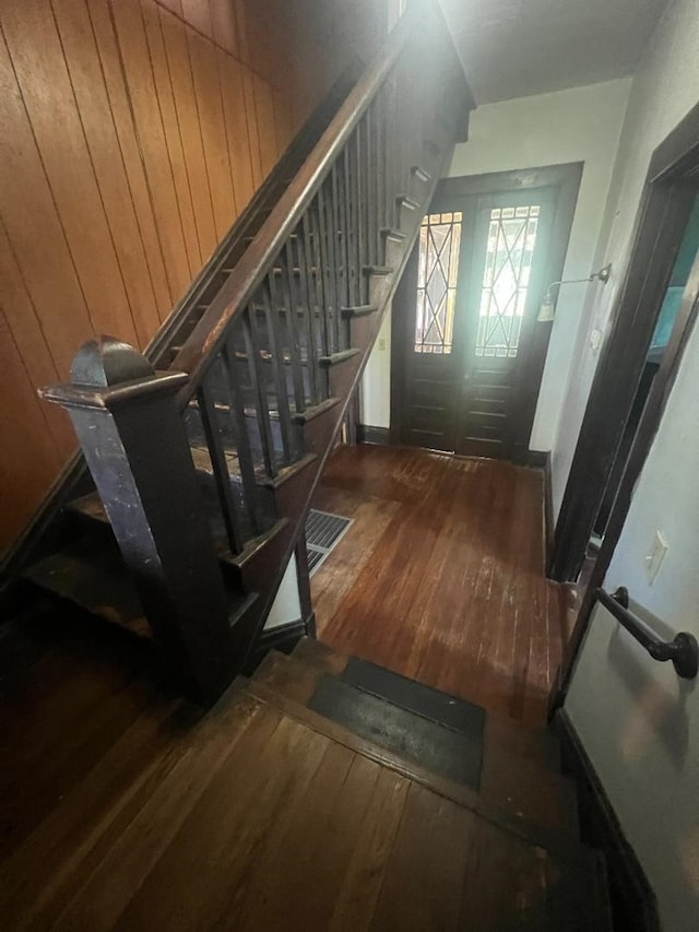 stairs featuring hardwood / wood-style flooring