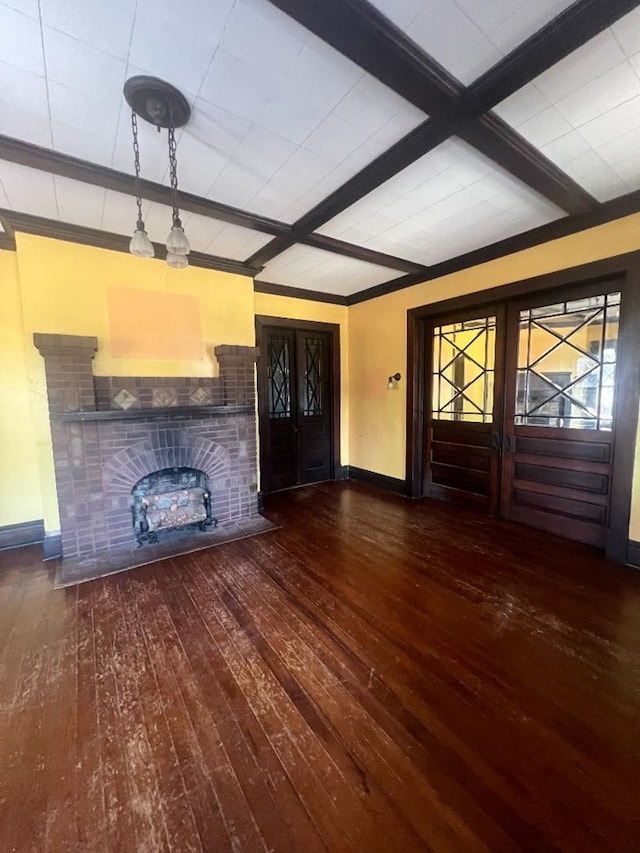 unfurnished living room featuring a fireplace, beam ceiling, and dark wood-type flooring