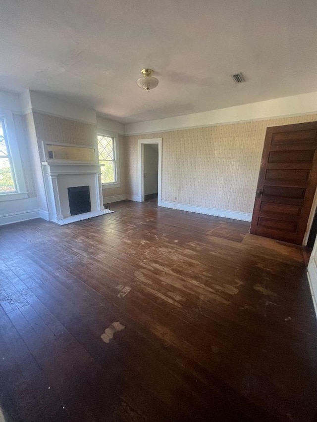 unfurnished living room featuring dark wood-type flooring