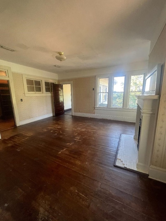 unfurnished living room with dark wood-type flooring