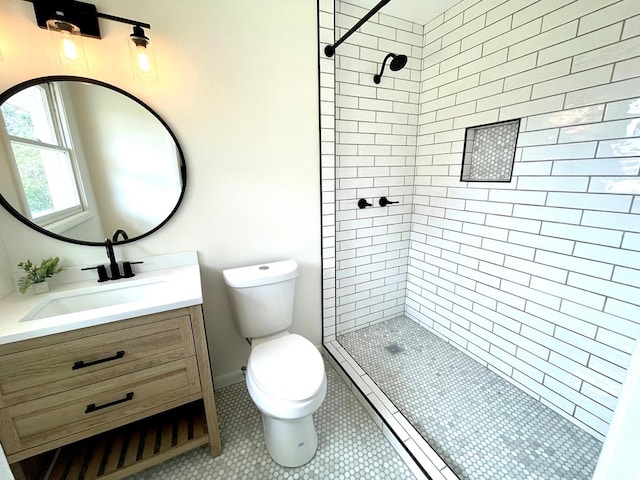 full bath featuring a stall shower, tile patterned flooring, vanity, and toilet