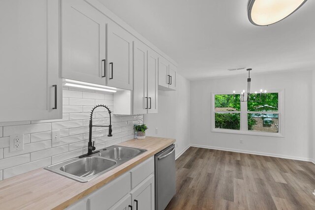 685 Hodgesville Rd, Dothan, AL 36301 - kitchen featuring decorative backsplash, dishwasher, a sink, light countertops, and baseboards