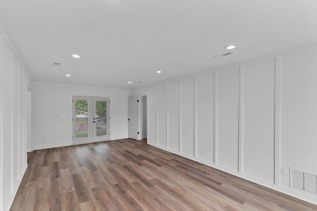 685 Hodgesville Rd, Dothan, AL 36301 - unfurnished room featuring visible vents, recessed lighting, a decorative wall, and wood finished floors